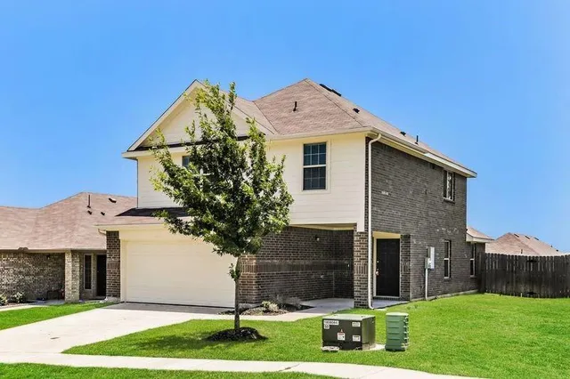 a front view of a house with a yard