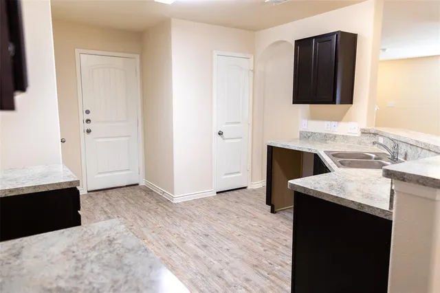 a kitchen with a sink and a refrigerator