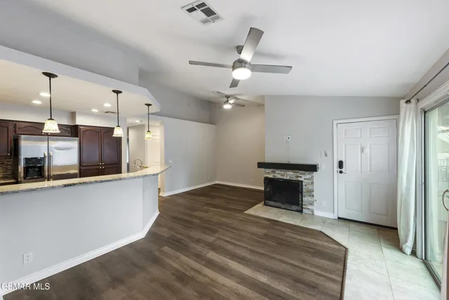 a view of a kitchen with a sink and a fireplace