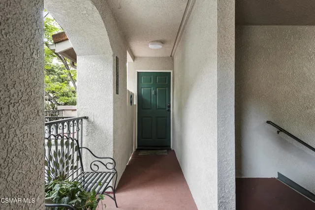 a view of a hallway with wooden floor and glass door