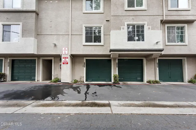 a front view of a brick house with a garage