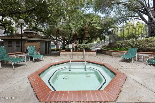 a swimming pool with outdoor seating and yard