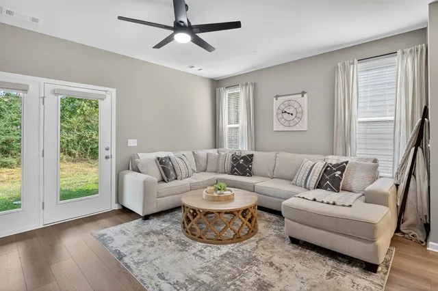 a living room with furniture and a large window