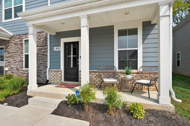 a view of a house with backyard sitting area and garden