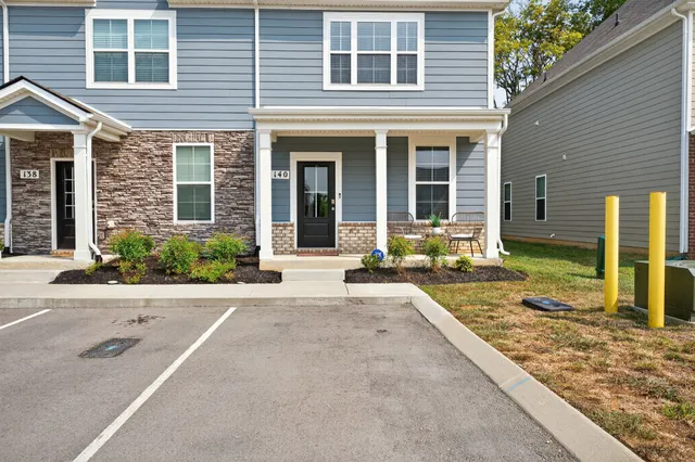 a front view of a house with a yard and glass windows