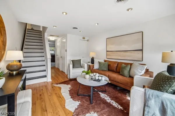a living room with furniture and wooden floor