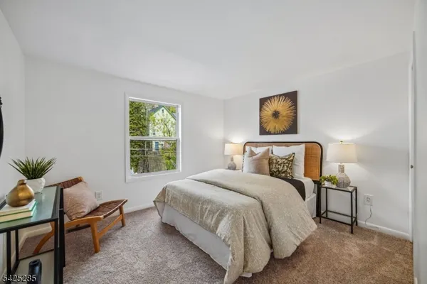 a bedroom with a bed and chair