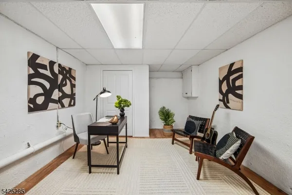 a living room with furniture and wall paintings