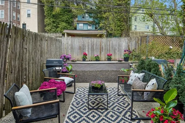 a view of outdoor sitting area with furniture and wooden fence