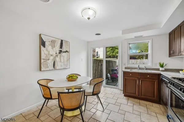 a view of a kitchen area with furniture and wooden floor