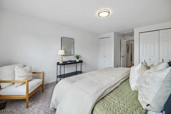 a bedroom with a bed and a couch