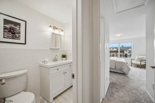 a en suite bathroom with a toilet sink and mirror