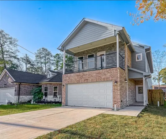 a front view of a house with a garden and yard