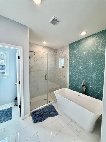 a bathroom with a bathtub and shower
