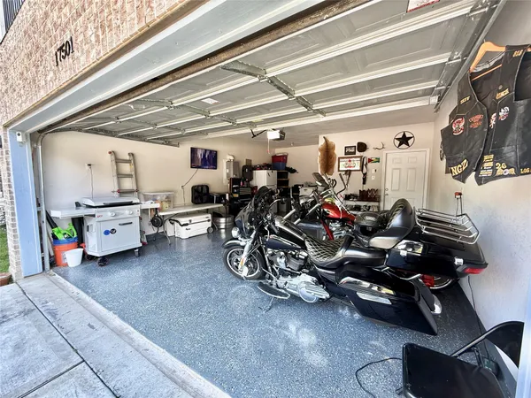 a spacious bathroom with a shower a sink and a mirror