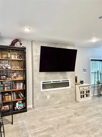 a living room with lots of furniture and kitchen view