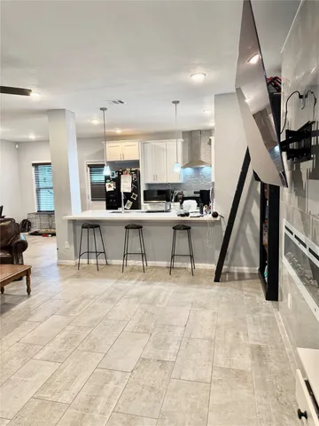 a living room with lots of furniture and kitchen view