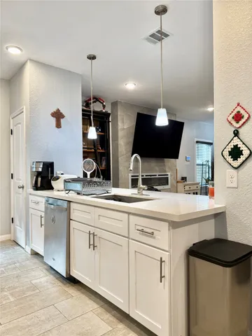 a kitchen with a sink and a stove top oven