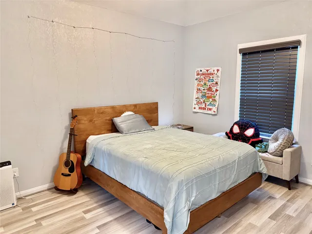 a bedroom with a bed and a potted plant