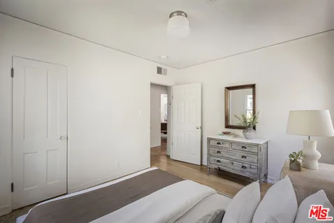 a bedroom with a bed and glass door