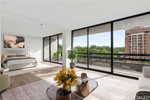 a lobby with furniture and floor to ceiling window