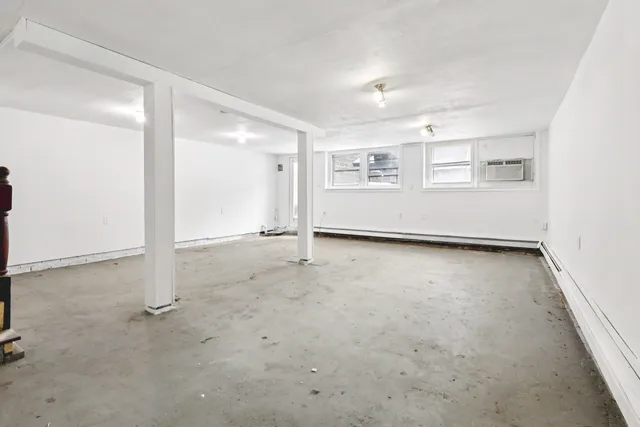 an empty room with white walls and stairs
