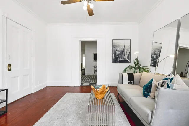 a living room with furniture and a wooden floor