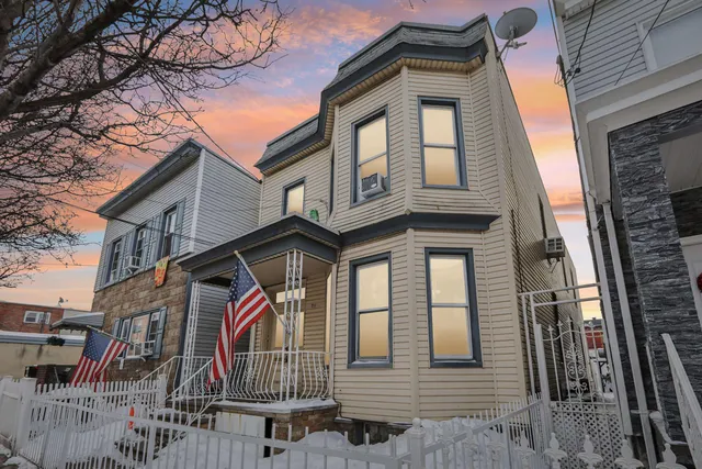 a front view of a house with large windows