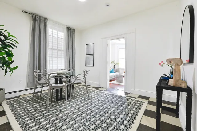 a living room with furniture rug and window