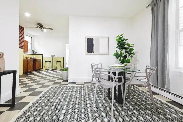 a dining room with furniture and window