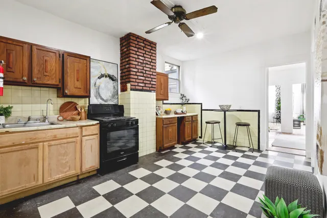 a kitchen with a stove a sink and a cabinets