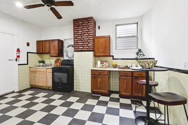a kitchen with stainless steel appliances granite countertop a stove a sink a refrigerator and a microwave