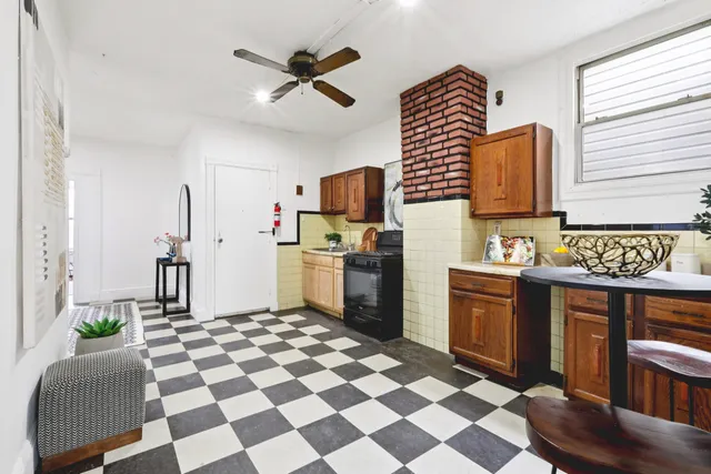 a kitchen with stainless steel appliances granite countertop a sink and a refrigerator