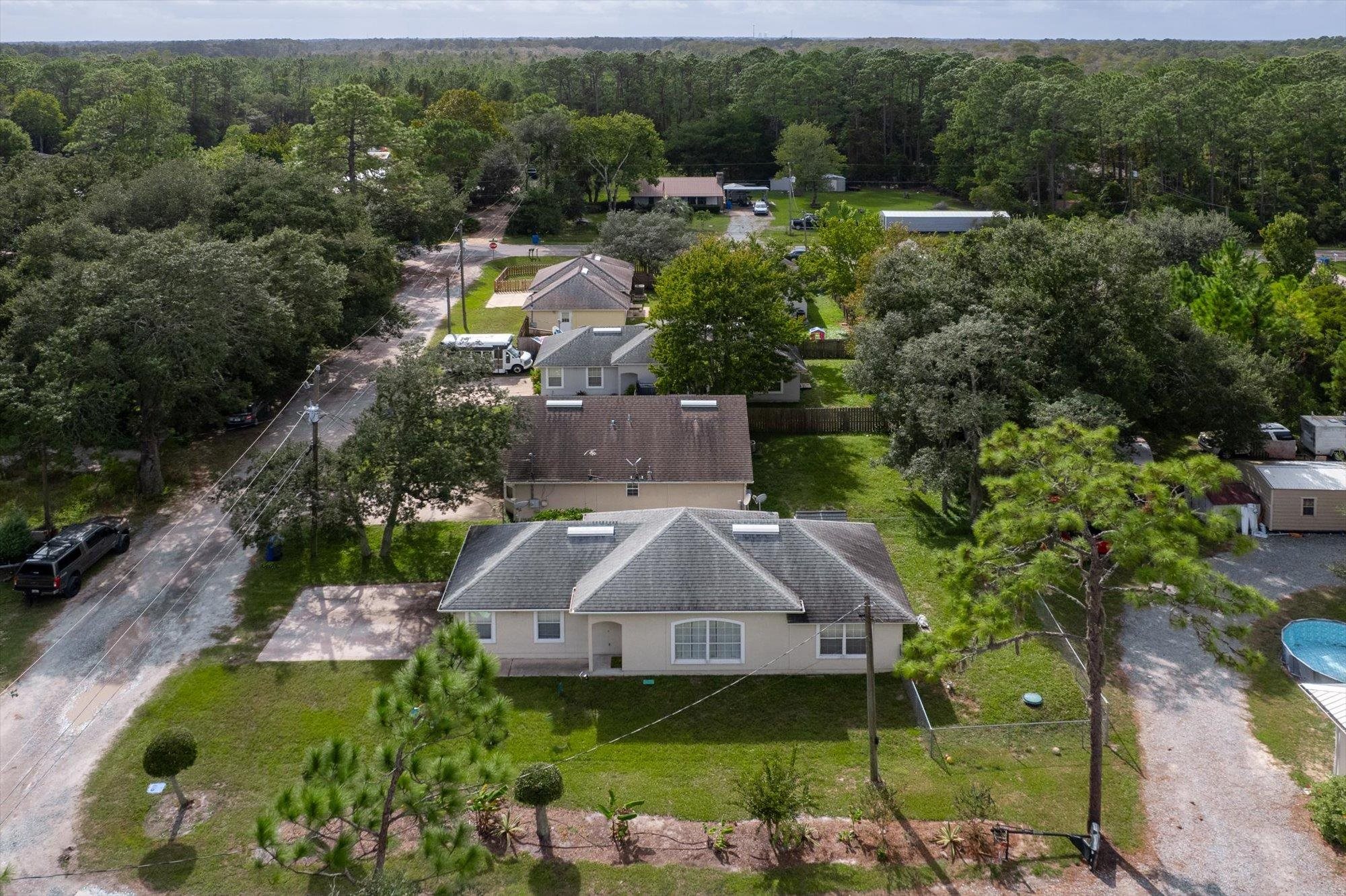 3372 4th Street Elkton, FL 32033 - Photo 31 of 36 a aerial view of a house with swimming pool patio and lake view