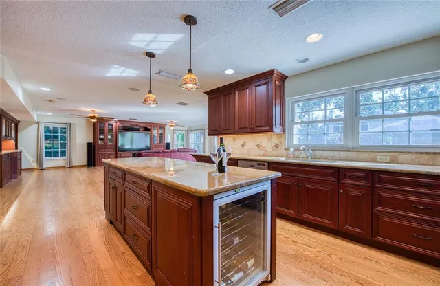 a view of a hallway view with wooden floor and a living room