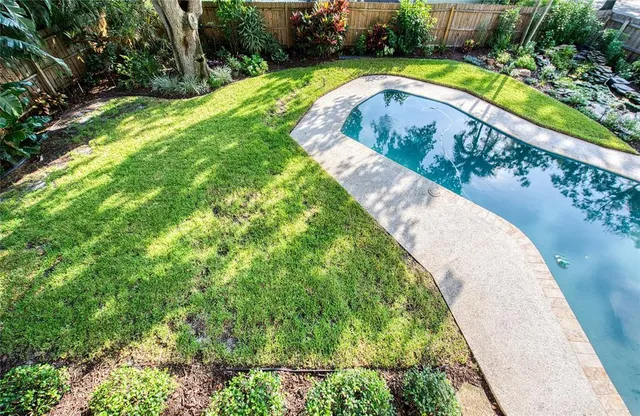 a view of a house with swimming pool and sitting area