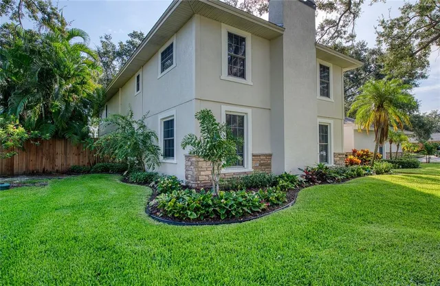 a view of a livingroom with furniture wooden floor and a ceiling fan