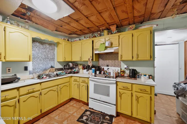 a kitchen with a sink a stove and cabinets