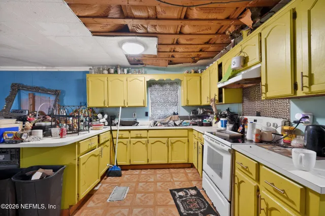 a view of a kitchen sink and natural light