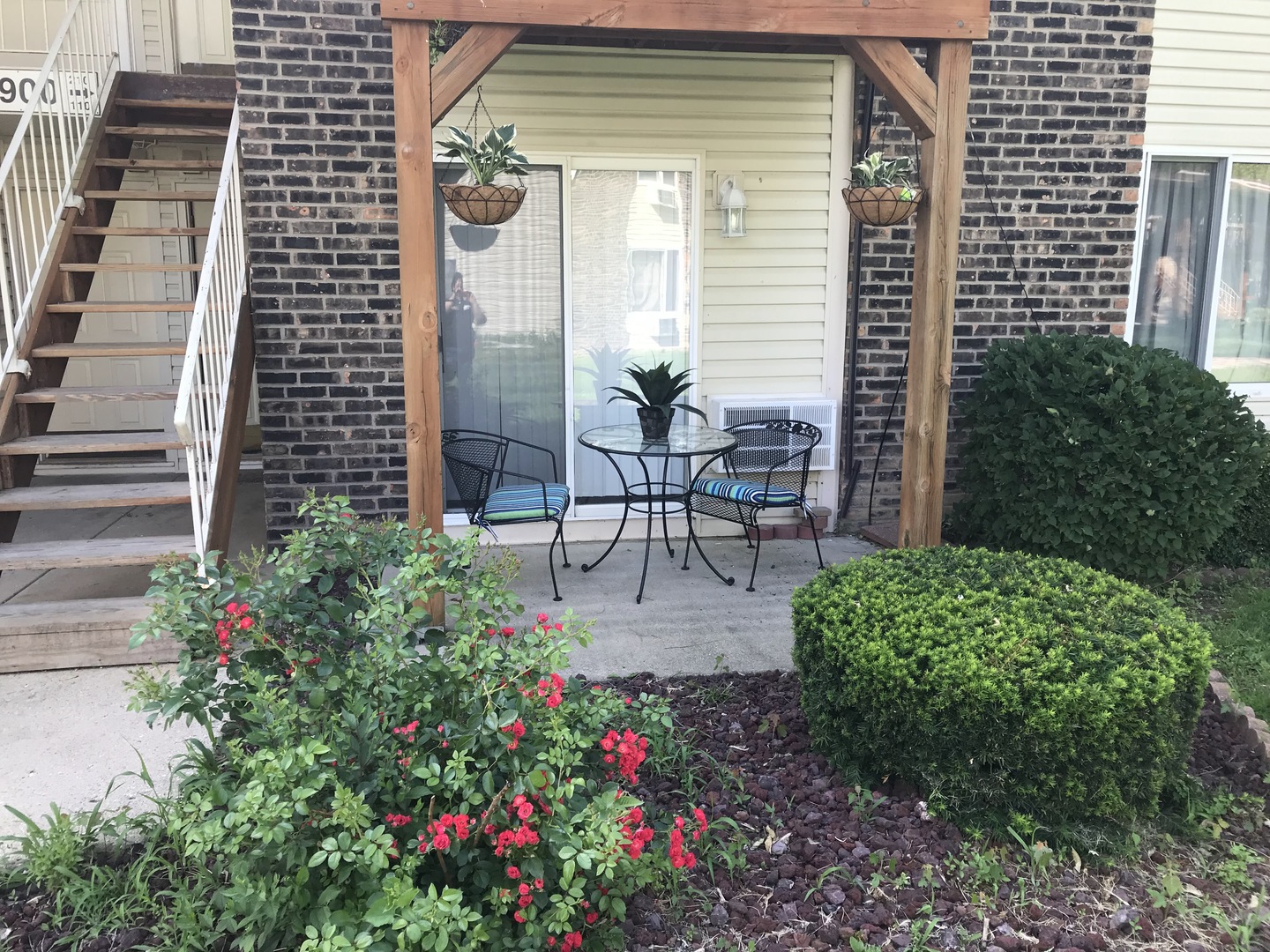 1900 Light Road, Unit 110 Oswego, IL 60543 - Photo 1 of 15 a view of a patio with plants and table and chairs and potted plants