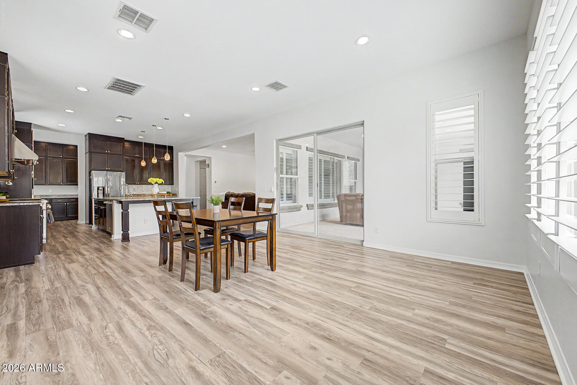 1076 East Kensington Road Gilbert, AZ 85297 - Photo 7 of 73 a view of a dining room with furniture window and wooden floor