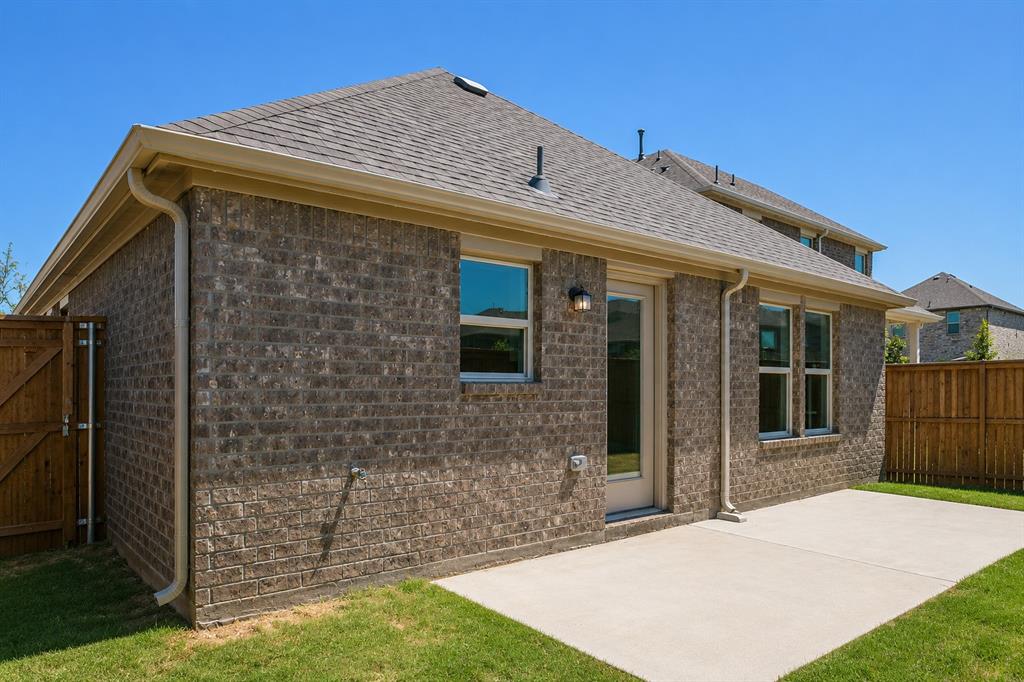 3344 Duncan Way Corinth, TX 76210 - Photo 28 of 38 Outdoor patio area featuring a concrete slab and a manicured lawn