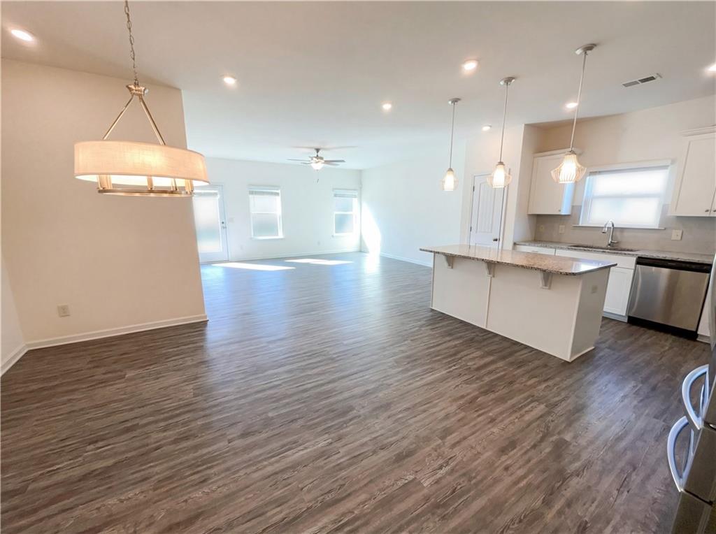 2682 North Broad Street Extension Northeast Rome, GA 30161 - Photo 6 of 23 a view of a kitchen with kitchen island a chandelier and wooden floor