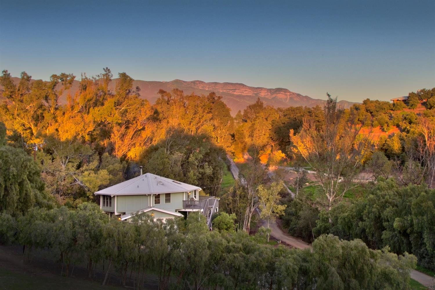 304 Fairview Road Ojai, CA 93023 - Photo 4 of 32 a view of a house with a mountain and a forest