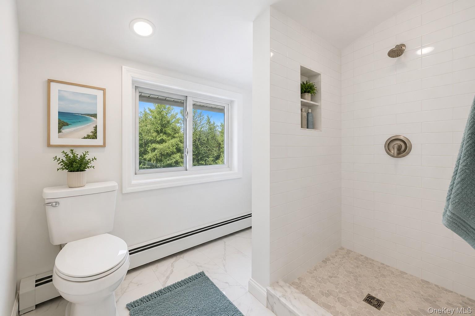 785 Locksley Road Yorktown Heights, NY 10598 - Photo 10 of 16 Bathroom featuring a walk-in shower with white subway tile, a recessed shower niche, and a brushed nickel rain shower head photos have been digitally enhanced to illustrate the property's potential.