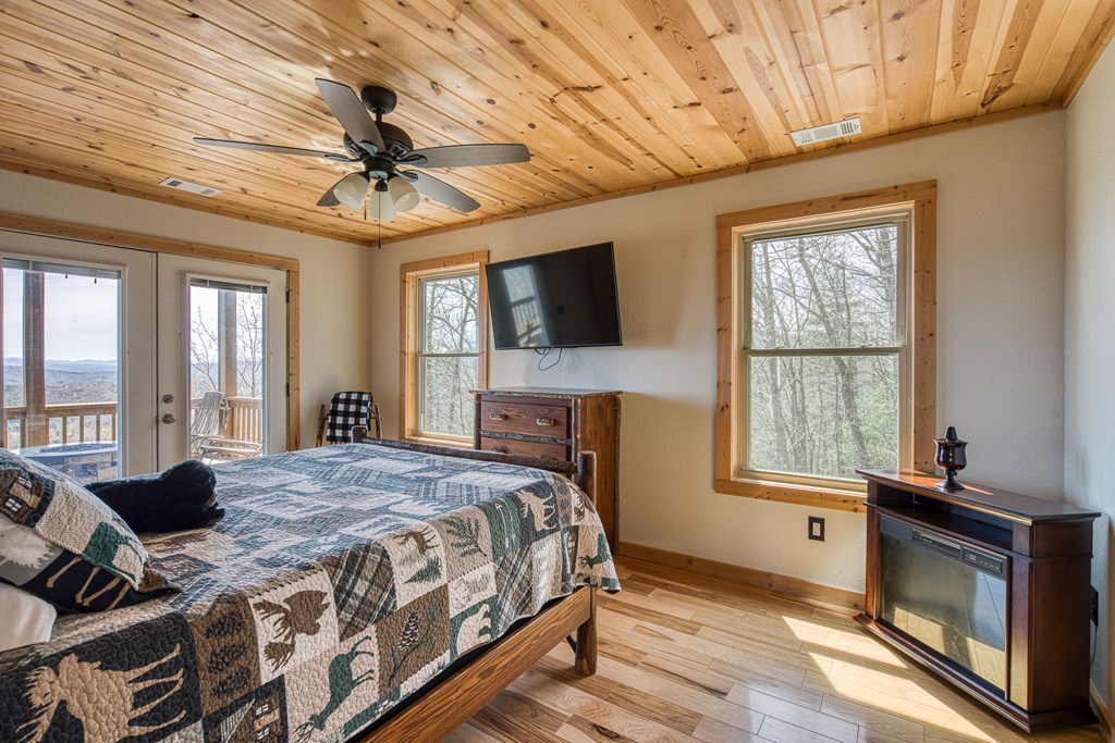 40 Reitzel Rdg Trail Murphy, NC 28906 - Photo 16 of 54 a bedroom with a bed next to a window with a flat screen tv