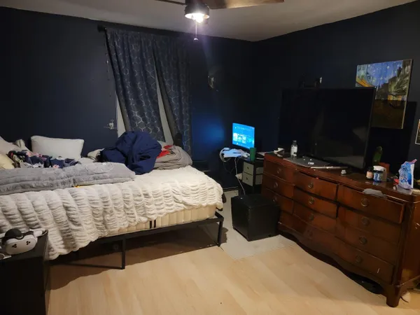 a bedroom with a bed and a flat screen tv