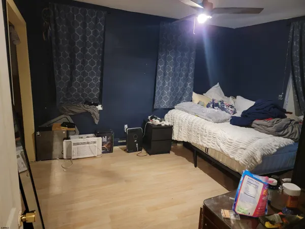 a bedroom with bed and a chair