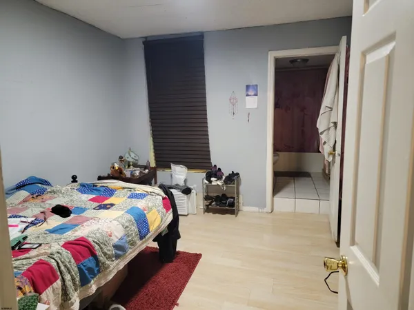 a bedroom with a bed and a chair