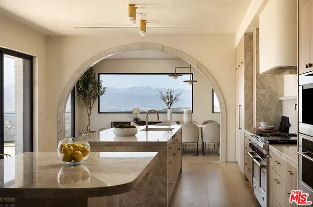 a kitchen with a sink and a stove top oven